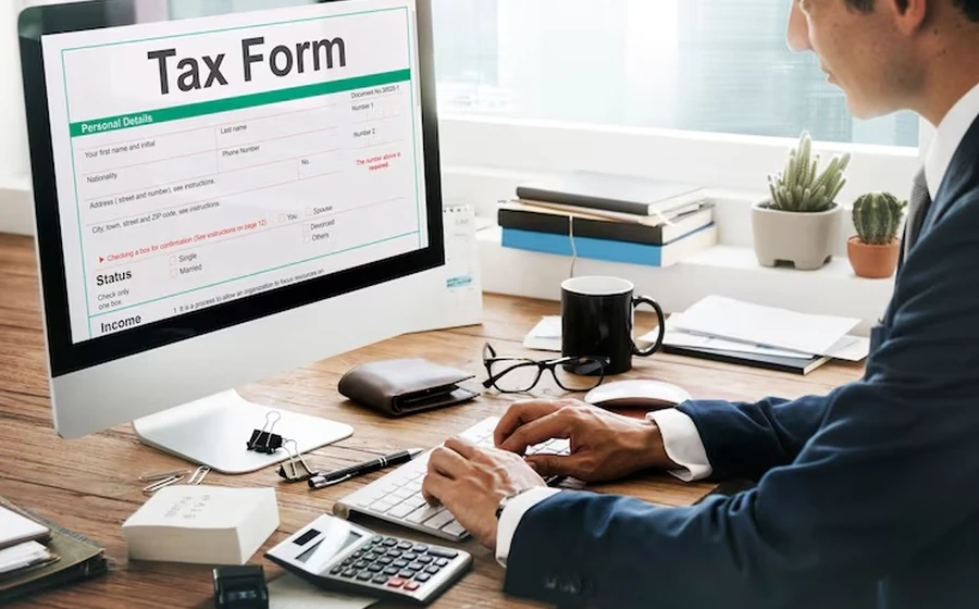 Tax documents and calculator representing tax preparation